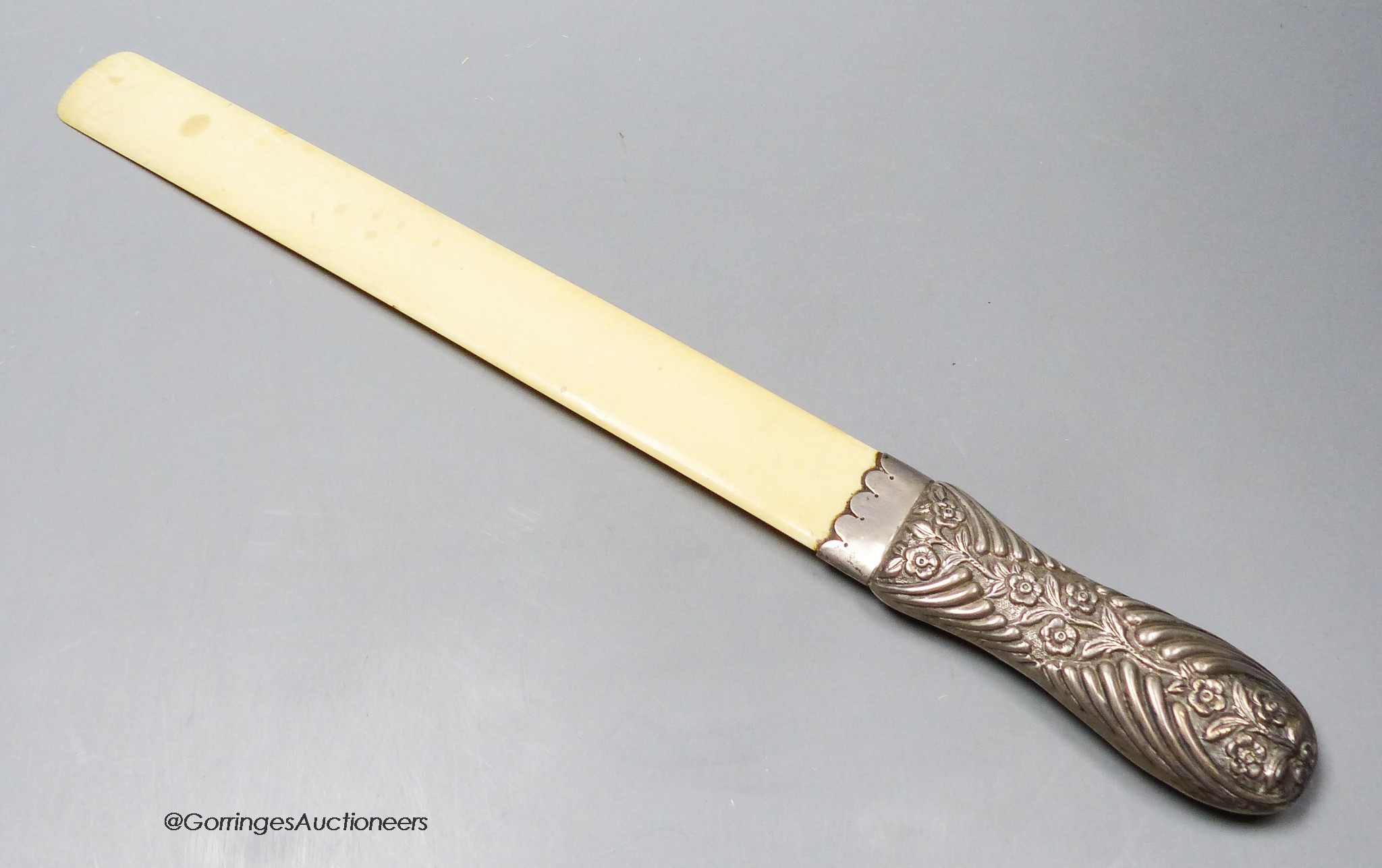 A late Victorian repousse silver handled ivory page turner, Edmund Bennett, London, 1896, 41.9cm.